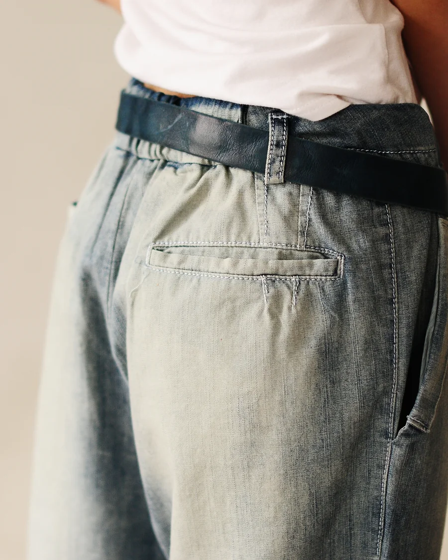 Back pleat and pocket on light-wash trousers
