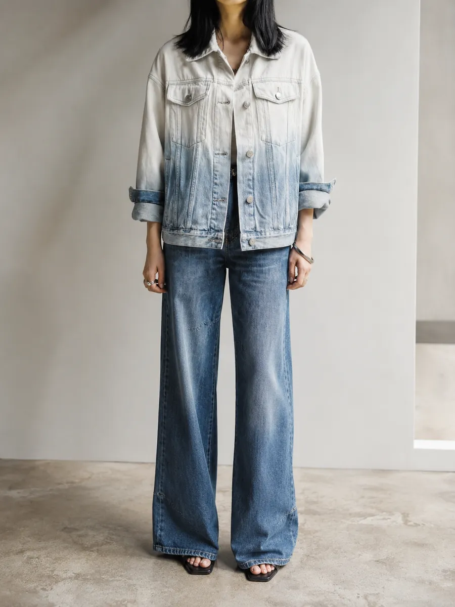 Bleached-gradient denim jacket worn with wide indigo jeans, full length
