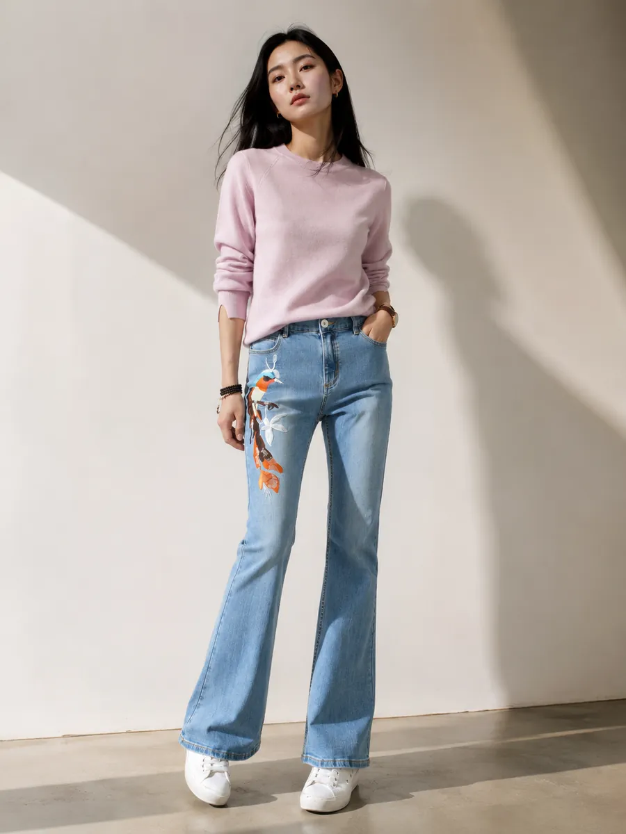 Light flared jeans with embroidered koi at the knee